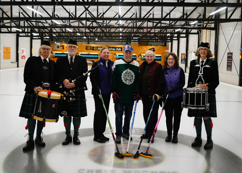 Four curlers particpating in Curl For A Cause joined by members of  Fergus Pipe Band.