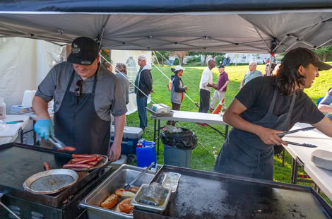 Le Chien Chaud owner and employee serving their hotdogs