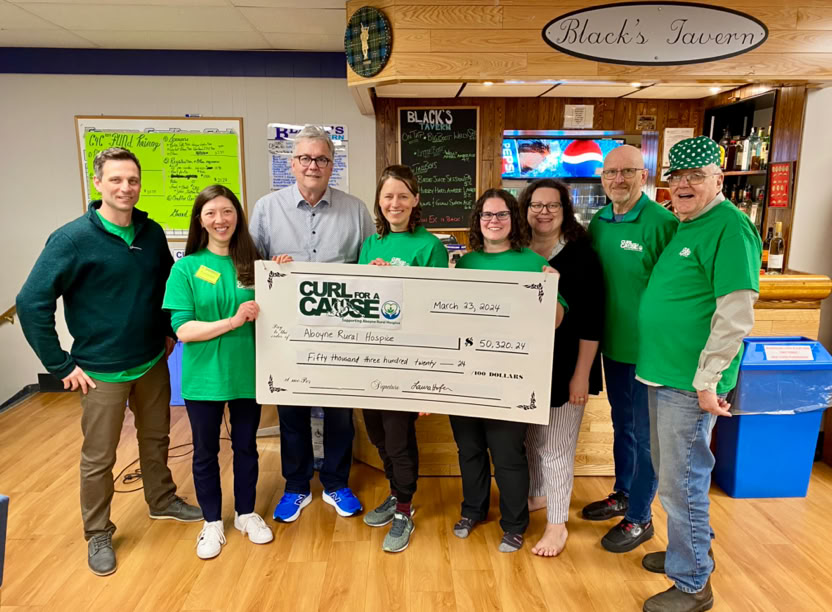 Photograph of 2025 Curl for a Cause Volunteers with cheque