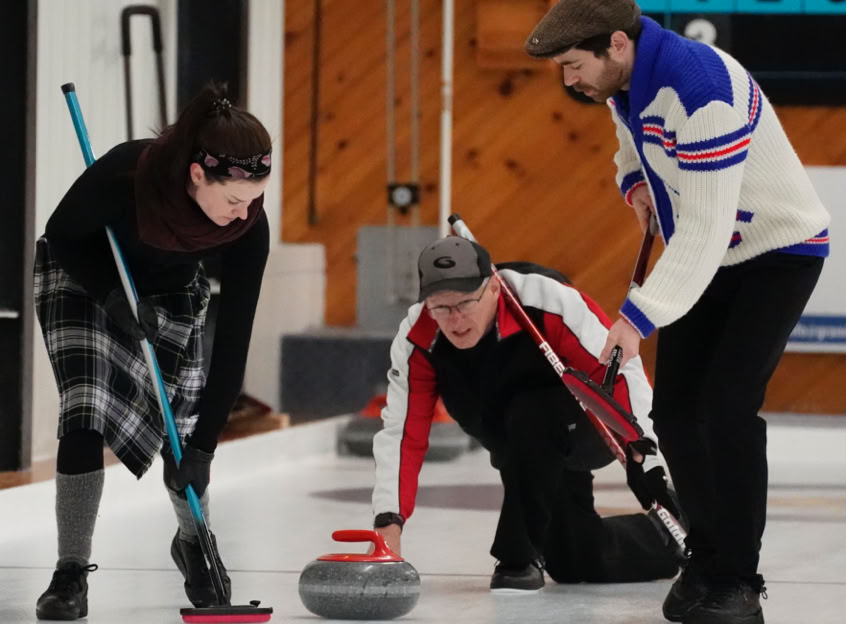 One woman and two men competing at 2023 Curl For A Cause.